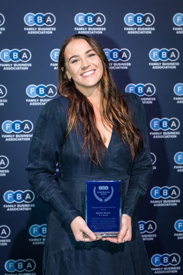 A person holding a blue awardDescription automatically generated with low confidence